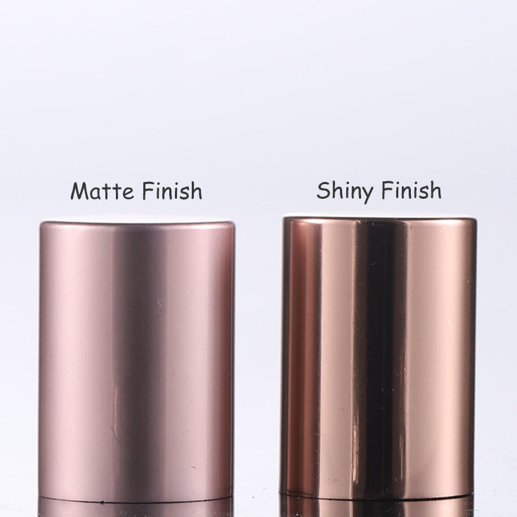 Comparison of matte and shiny finish roll-on perfume bottles in rose gold color.