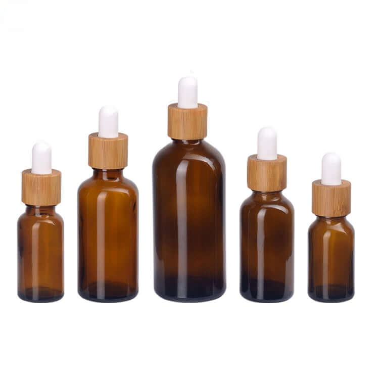 100PCS/Lot amber glass dropper bottles in various sizes with bamboo caps, perfect for essential oils.