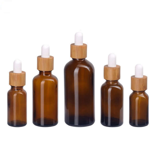 100PCS/Lot amber glass dropper bottles in various sizes with bamboo caps, perfect for essential oils.