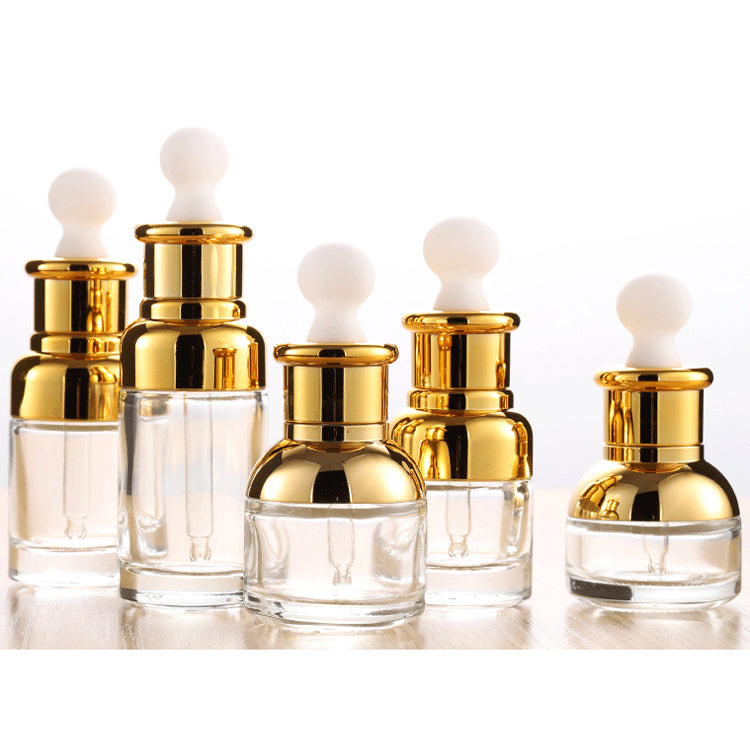 Set of 50PCS gold glass dropper bottles for essential oil, varying shapes with shiny caps, 30ml capacity.