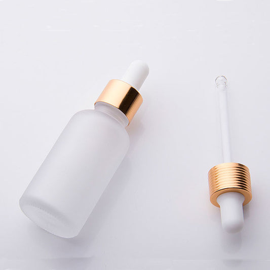 Cosmetic glass dropper bottles with pipette featuring a gold cap, ideal for essential oils and serums.
