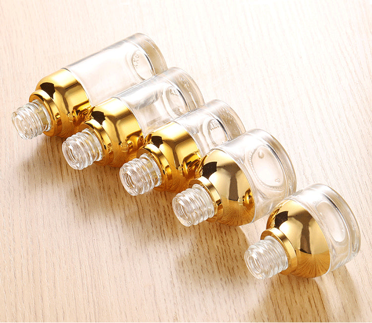 gold glass dropper bottles for essential oil with shiny caps, displayed in various shapes and sizes