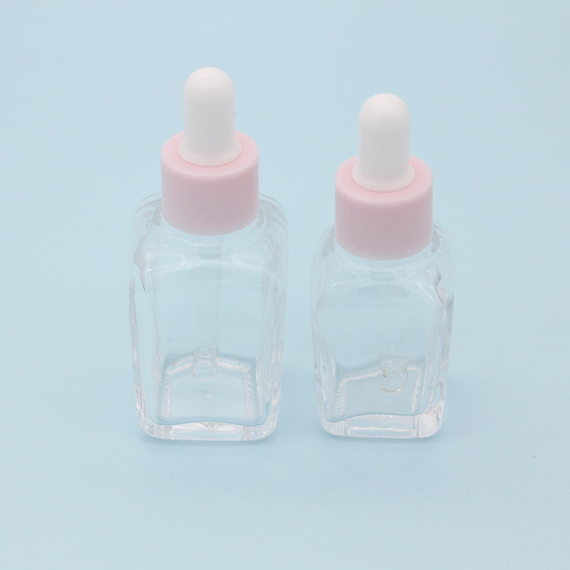 Clear glass dropper bottles for essential oils - 240PCS/lot, featuring pink caps and suitable for 20ml and 30ml sizes.