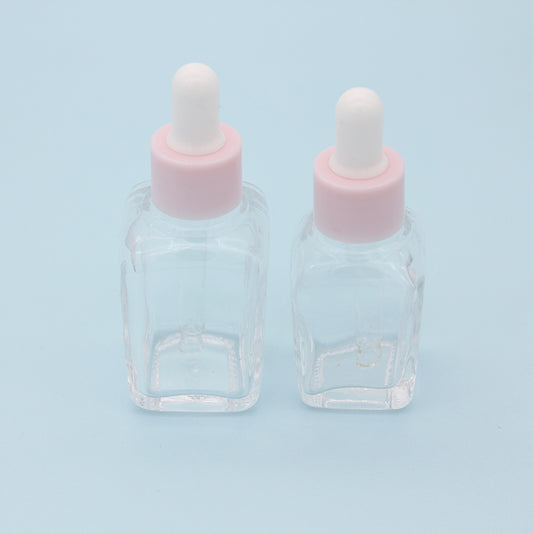 Clear glass dropper bottles for essential oils - 240PCS/lot, featuring pink caps and suitable for 20ml and 30ml sizes.