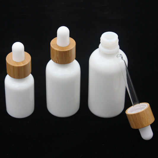 Set of whiteware essential oil bottles with bamboo dropper caps, available in 15ml, 30ml, and 50ml sizes.