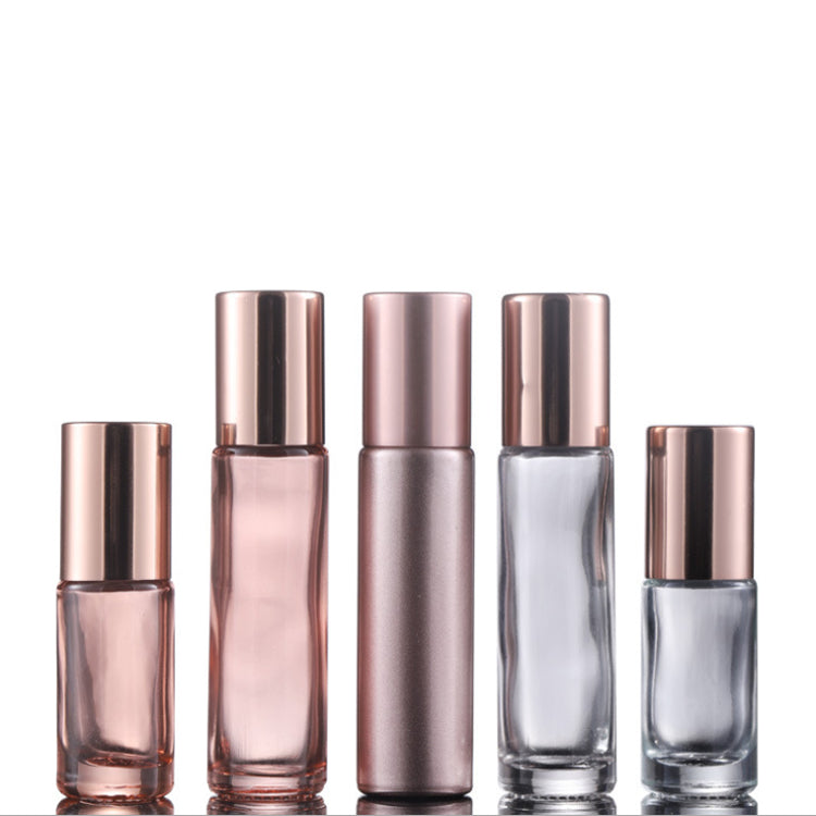 Set of rose gold roll-on perfume bottles in various sizes for essential oils and fragrances.