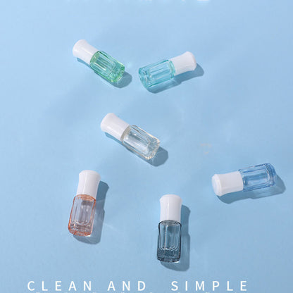 Colorful 3ml and 6ml glass essential oil roller bottles in various shades on a blue background.